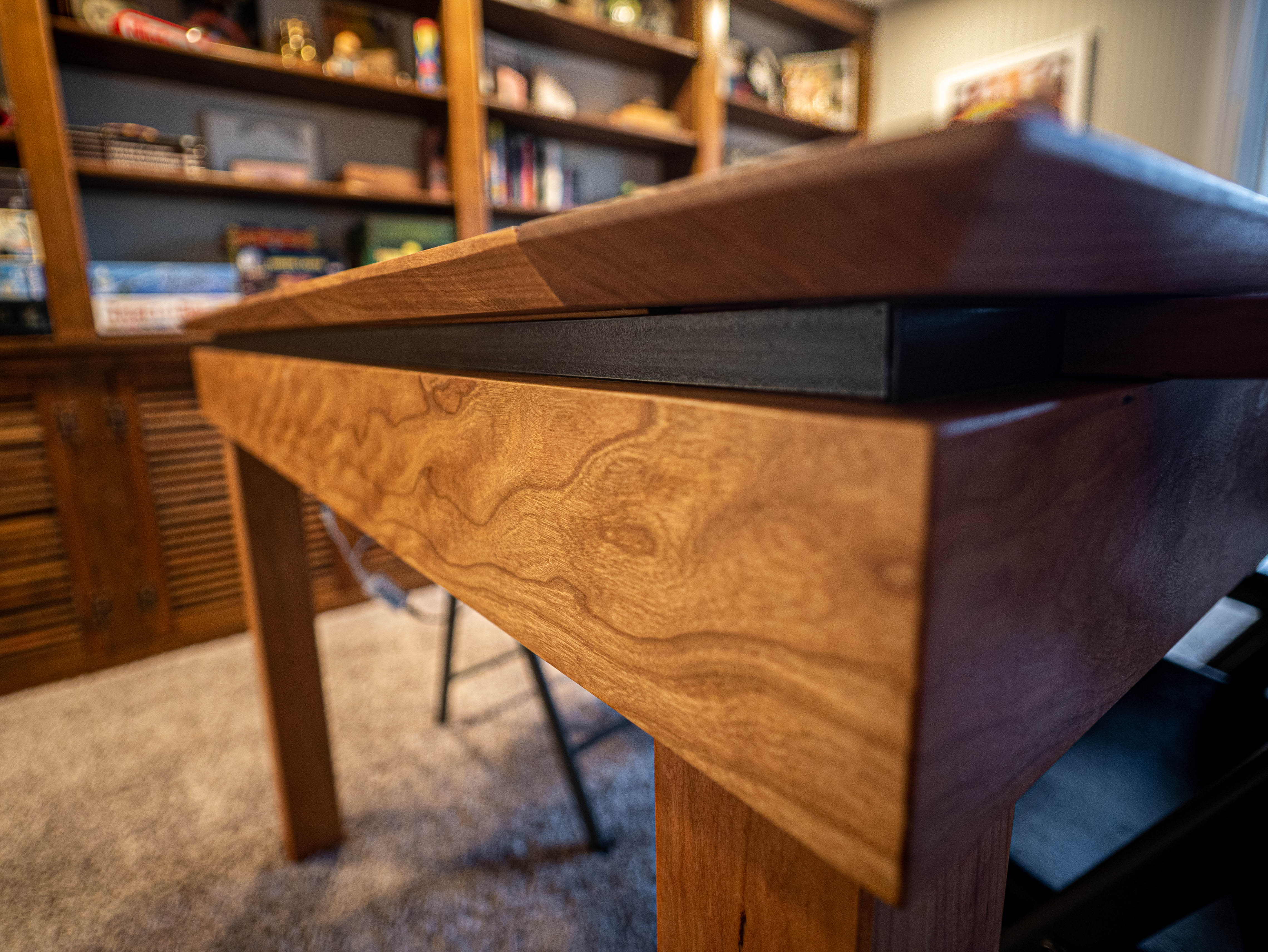 Close detail of the gaming table's cherry wood construction